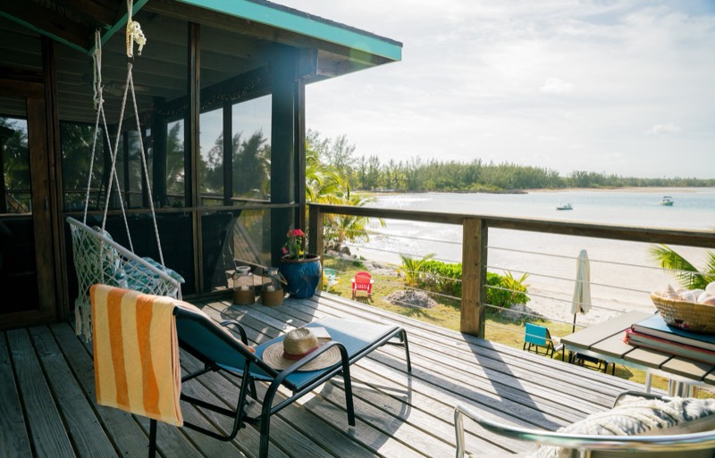 Golden afternoon light on the private deck, macrame swing and the beach below
